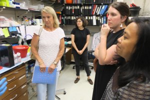 Tour group listens carefully about what goes on in the lab.